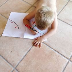 High angle view of girl sitting on floor