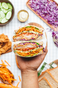 High angle view of person holding food on table