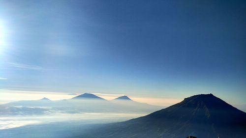 Scenic view of mountains against blue sky