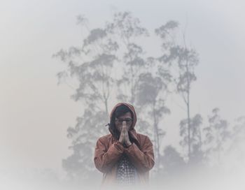 Portrait of young man against sky