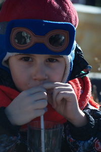 Portrait of boy drinking in winter