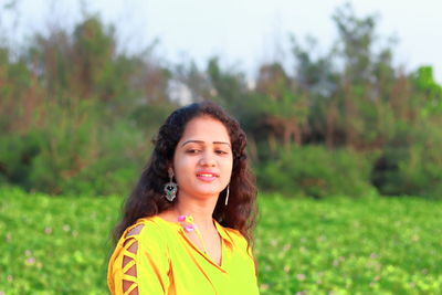 Portrait of smiling young woman standing outdoors