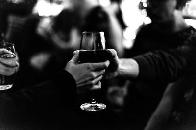 Midsection of man holding wineglass