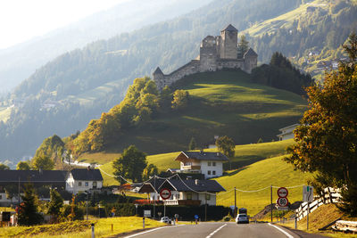 Low angle view of castle on green mountain