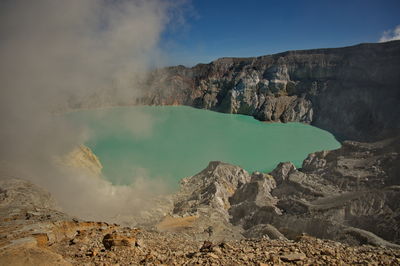 Scenic view of ijen volcano, indonesia with clouds above the crater