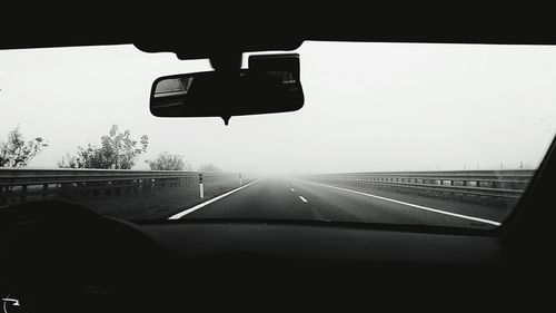 Close-up of car moving on road