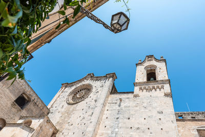 Low angle view of building against clear blue sky