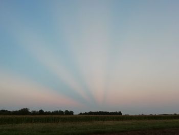 Scenic view of field against sky during sunset