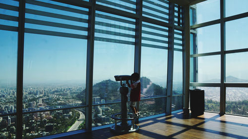 Man standing by window in city