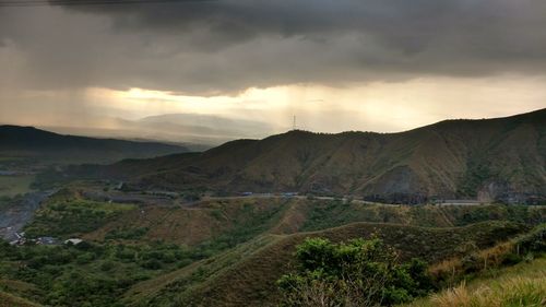 Scenic view of agricultural field against dramatic sky