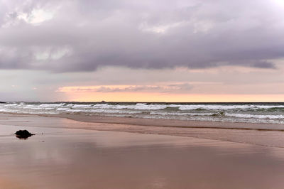 Scenic view of beach against sky during sunset