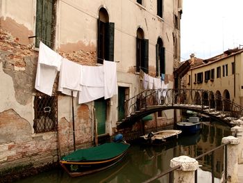 Boats in canal along buildings