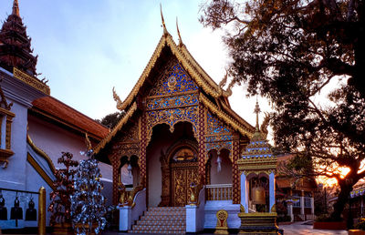 Low angle view of temple and building against sky