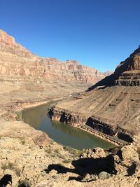 Scenic view of mountains against clear blue sky