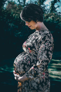 Midsection of woman standing by water