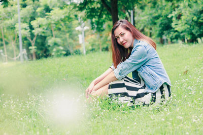 Portrait of woman sitting on grass