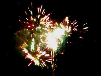 Low angle view of firework display at night