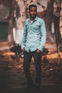Portrait of young man standing on land