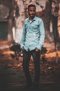 Portrait of young man standing on land