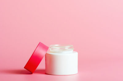 Close-up of pink bottle in jar on table