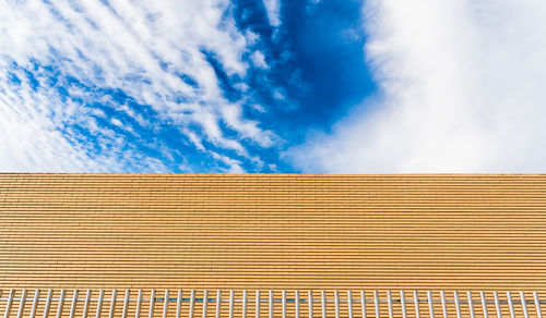 Low angle view of building against cloudy sky