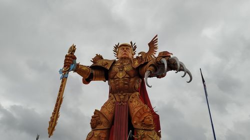 Low angle view of angel statue against sky