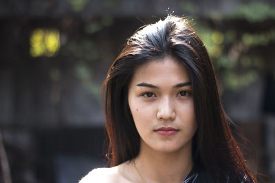 Portrait of young woman standing outdoors