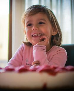 Smiling girl sitting at home