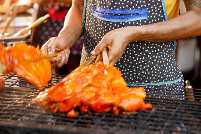 Midsection of man preparing food