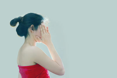 Woman standing against white background