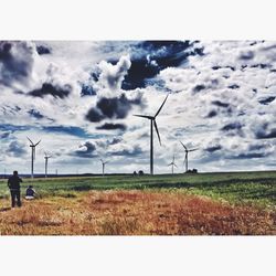 Wind turbines on grassy field