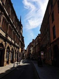 Street amidst buildings against sky in city