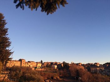 Buildings against clear blue sky