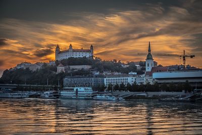 Sailboats in city during sunset