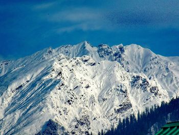 Scenic view of mountains against cloudy sky