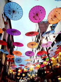 Low angle view of lanterns hanging in market against sky