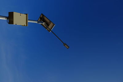 Low angle view of windmill against clear blue sky