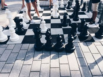 Low section of people standing chess floor