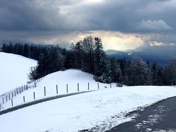 Snow covered field against sky