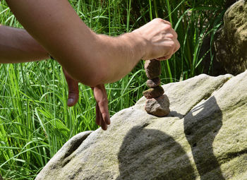 Close-up of man hand building a stone sculpture