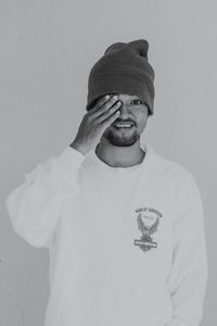 Portrait of man wearing hat against white background