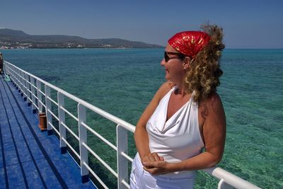 Woman looking at sea against sky