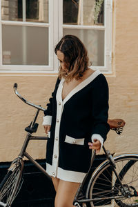 Side view of woman sitting on bicycle