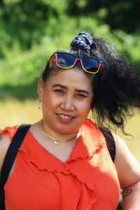 Portrait of smiling woman standing outdoors