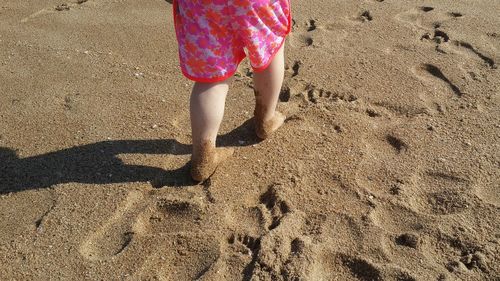 Low section of woman standing on beach