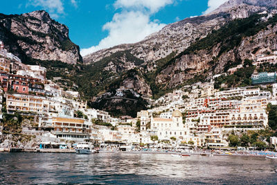 Scenic view of sea and mountains against sky