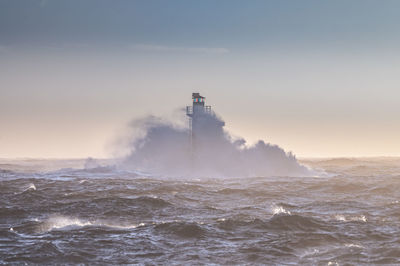 Lighthouse in stormy sea