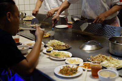 People preparing food on table