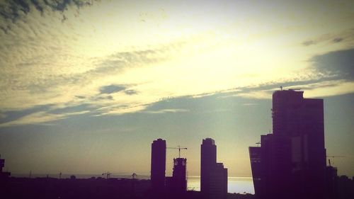Buildings against sky at sunset