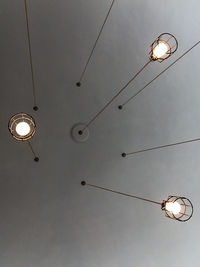 Directly below shot of illuminated light bulbs hanging from ceiling